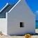 A hut on the beach near a rock with words that read White Slave